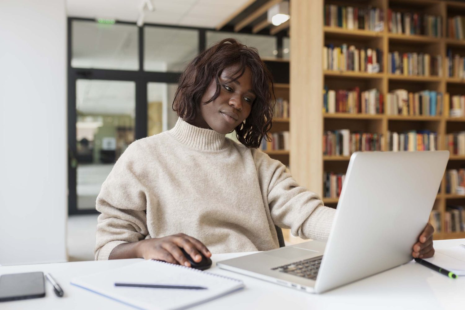 A reader browsing among library shelves